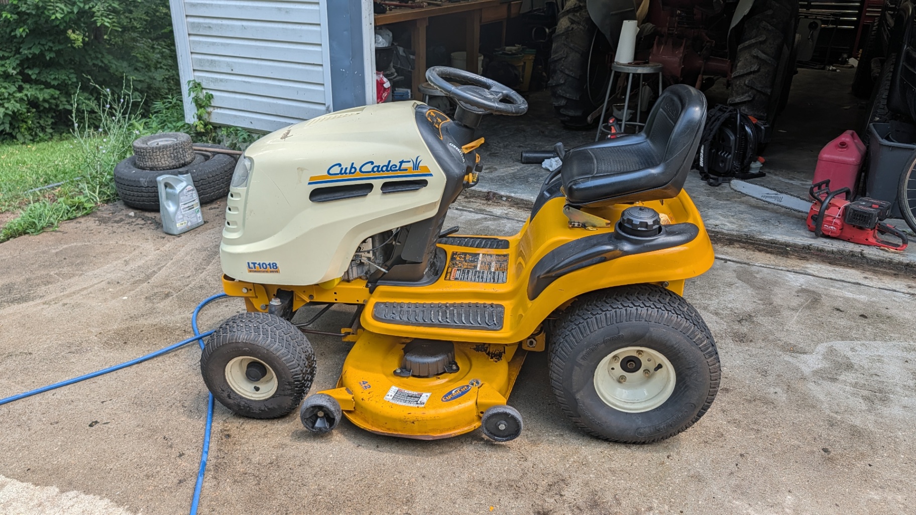 Cub Cadet LT1018 riding mower, side view outside the shop