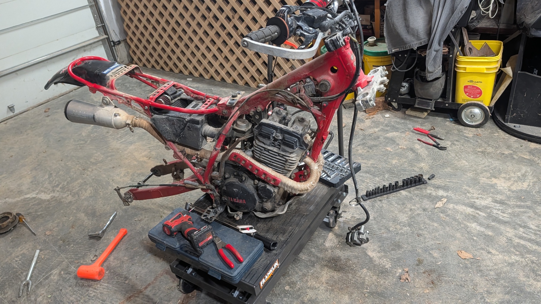 Yamaha 350 engine mounted in the bare frame during reassembly
