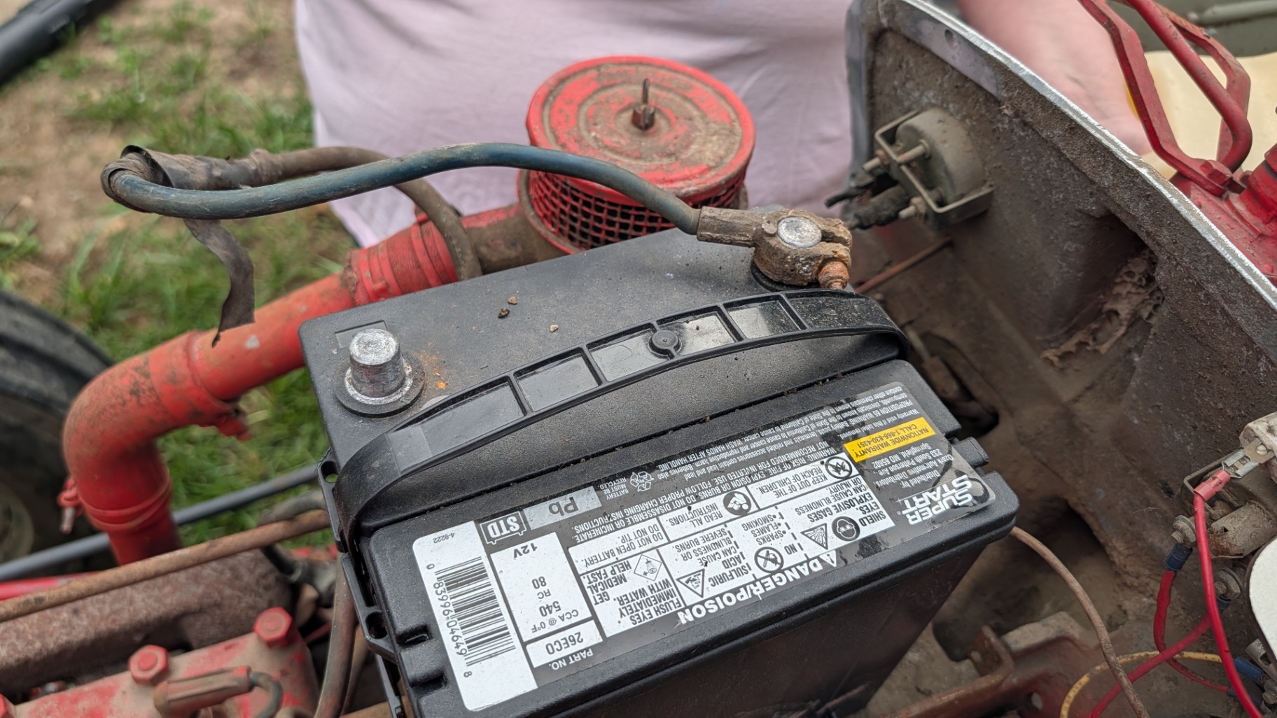 Close-up of heavy corrosion on a tractor battery post