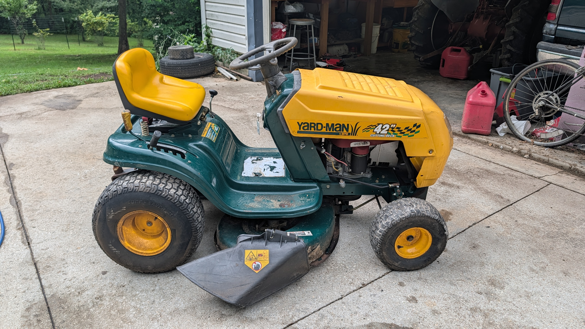 Green and yellow Yard-Man riding mower with 42 inch cutting deck