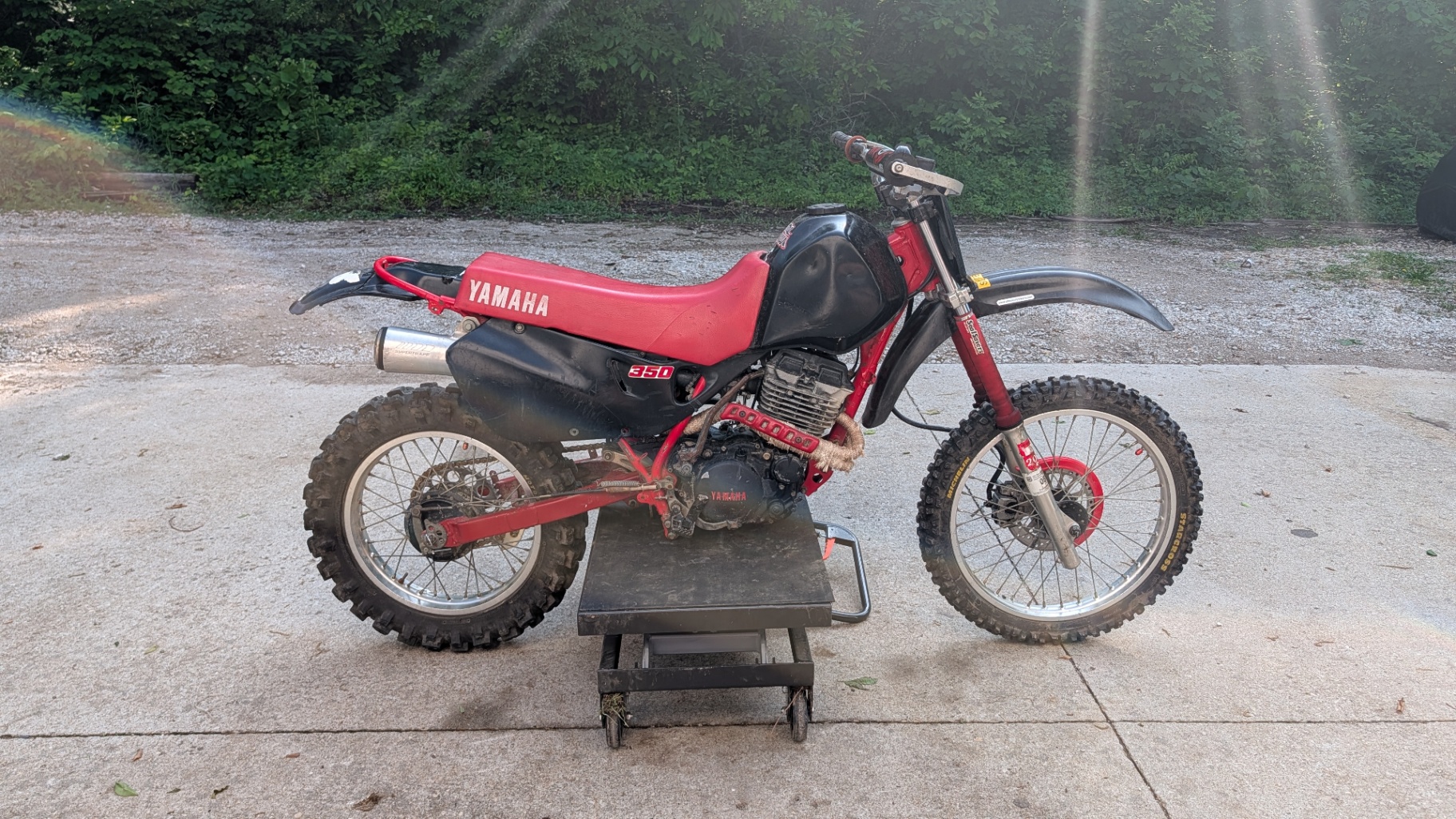 Red Yamaha 350 dirt bike on a lift after service