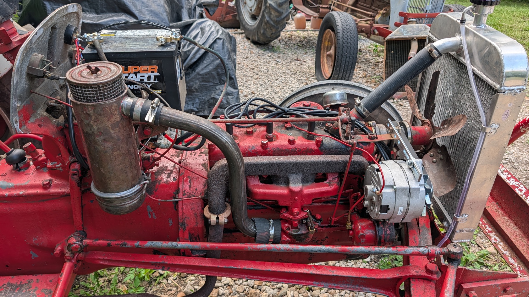 Antique red farm tractor engine with new aluminum radiator installed