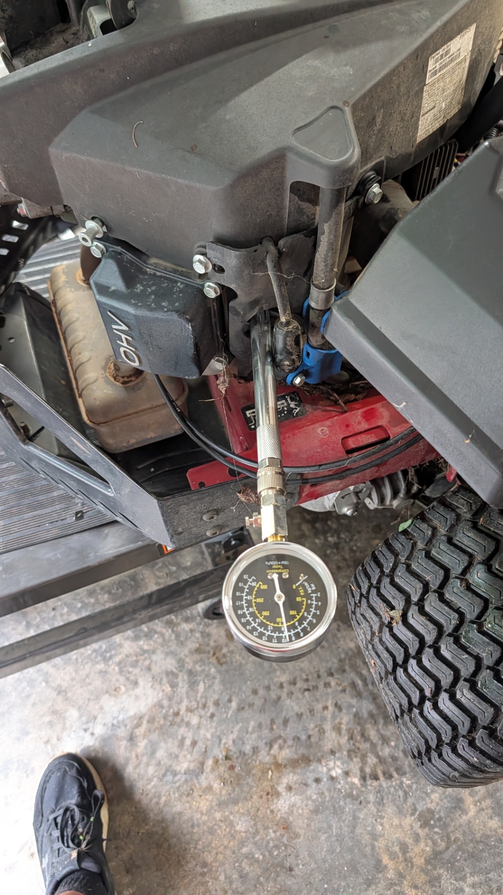 Compression tester hooked to a riding mower engine